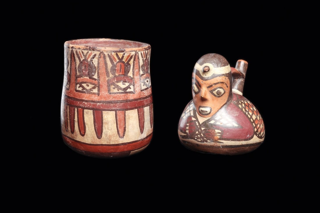 Nazca Polychrome Diver Effigy Vessel & Beaker, 2 pcs: Pre-Columbian, Peru, Nazca, ca. 100–600 CE. A pair of small polychrome slip-painted earthenware vessels from the south coast of Peru. The first is an anthropomorphic effigy jar, its modeled head