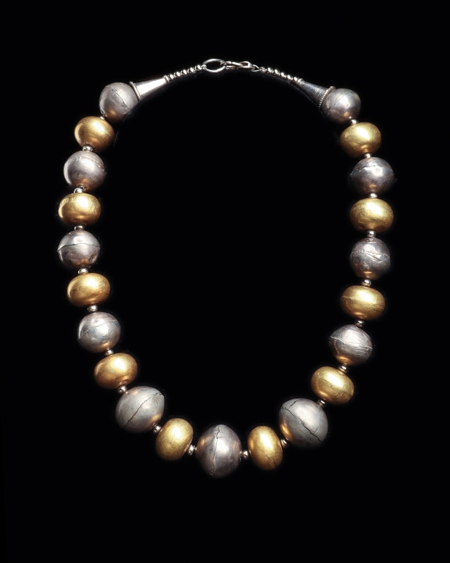 Inca Gold and Silver Ball Bead Necklace: Pre-Columbian, Peru, Inca, ca. 1000–1425 CE. A weighty procession of hollow spheres, ten of gold and eleven of silver, alternating around the throat in a rhythm of warm and cool light. Each bead