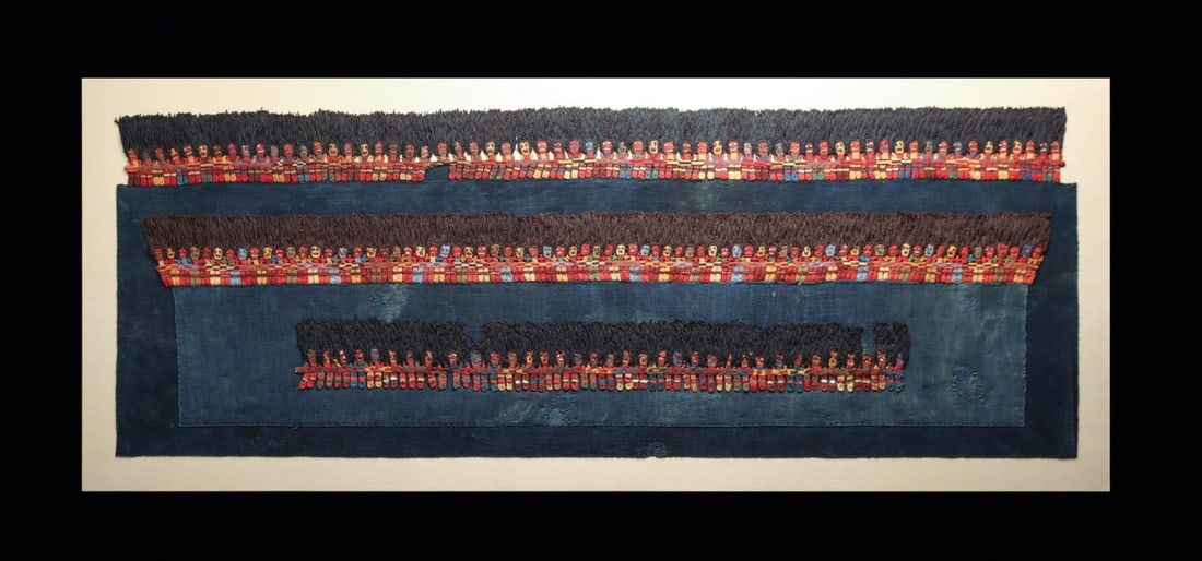 Nazca Munekas Textile Border Panels with Knit Figures, Framed (3): Pre-Columbian, Peru, Nazca, ca. 100–600 CE. A parade of some 190 tiny knit figures marches across three mantle border sections, worked in dyed alpaca fiber by the single-needle cross-knit loopin