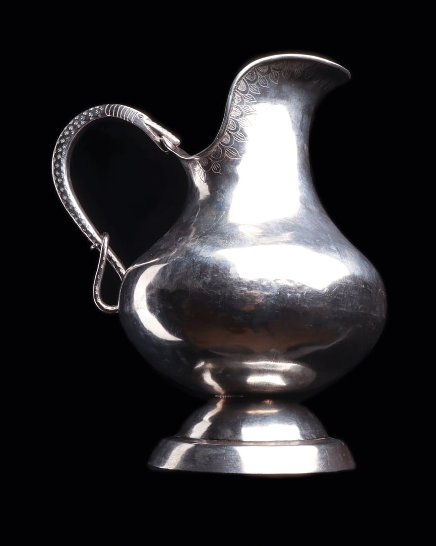 Spanish Colonial Silver Ewer with Serpent Handle, Bolivia, Late 18th C.: South America, Bolivia, Spanish Colonial, ca. 1760–1800 CE. A serpent climbs the back of this hand-raised silver ewer, its jaws clasping the rim and its tail curling down to grip the swelling be