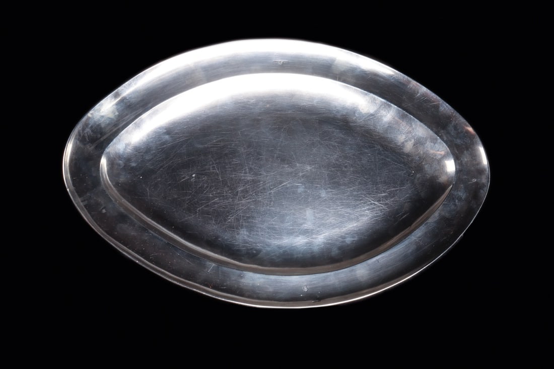 Spanish Colonial Fish Platter, Mexico City, Marked Forcada, Ca. 1790-1810: Central America, Mexico, Mexico City, Spanish Colonial, ca. 1790–1810 CE. A broad oval dish of hand-raised silver, its shallow well framed by a wide sloping rim that swells to gentle points at e
