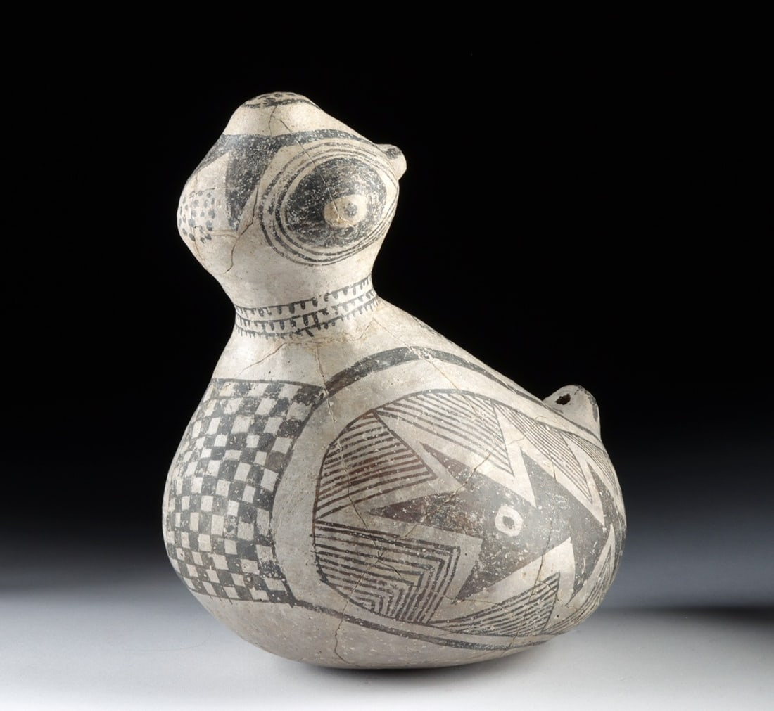Ancestral Puebloan Tularosa Black-on-White Bird Effigy: Native American, Ancestral Puebloan (Anasazi), Tularosa Black-on-White, ca. 1100–1300 CE. A ceramic bird effigy vessel, with a rounded body rising into a tail and an upturned head, the eyes ring