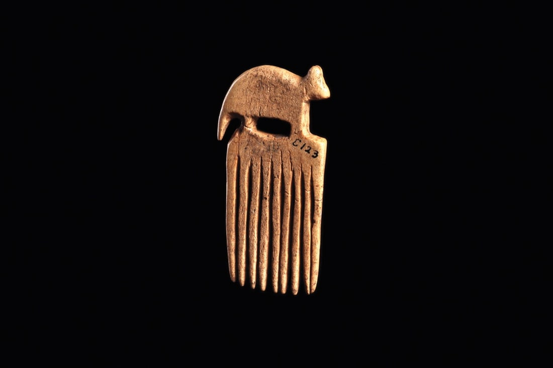 Iroquois Bone Effigy Comb with Raccoon Finial, Cameron Site, NY: Native American, Iroquois, Cameron Site, Madison County, New York, ca. 1600–1750 CE. A miniature comb cut from a single sliver of bone, its openwork crest carved as a stylized raccoon standing i