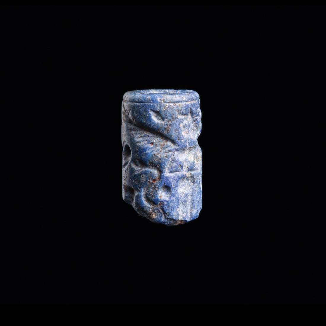 Assyrian Lapis Lazuli Cylinder Seal with Winged Goddess and Serpents: Near East, Mesopotamia, Assyrian, ca. 1700–1500 BCE. A miniature cylinder of deep blue lapis lazuli, its curved face engraved in intaglio so that a single roll across damp clay unfurls a divine 