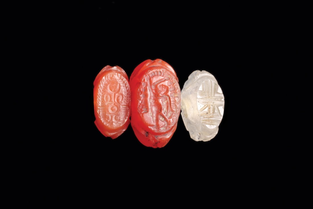 Sasanian Agate Stamp Seals, Winged Figure and Altar, Group of 3: Western Asia, Persia, Sasanian Empire, ca. 400–600 CE. A trio of dome-shaped agate stamp seals, two warm orange and one near-colorless, each body faceted with shallow circular hollows and pierce