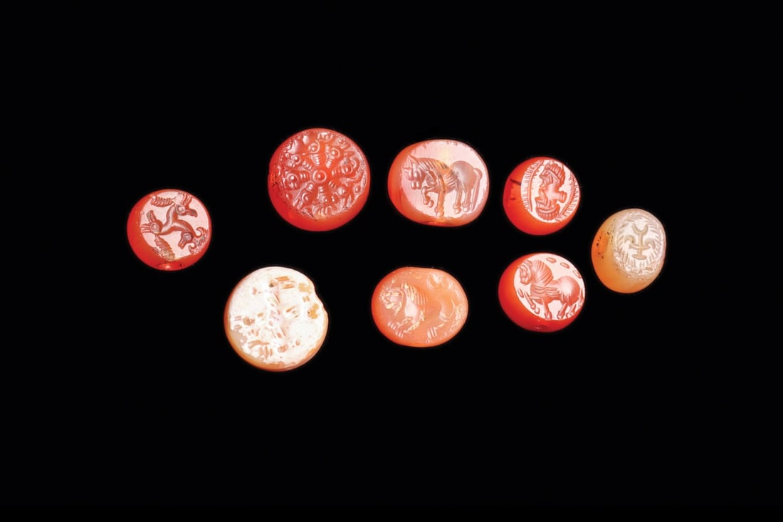 Sasanian Agate Stamp Seals with Horses, Lions and Rosette, Group of 8: Western Asia, Persia, Sasanian Empire, ca. 400–600 CE. A group of eight domed agate stamp seals, each in warm orange to pale honey stone, polished to a rounded dome and drilled through for suspe