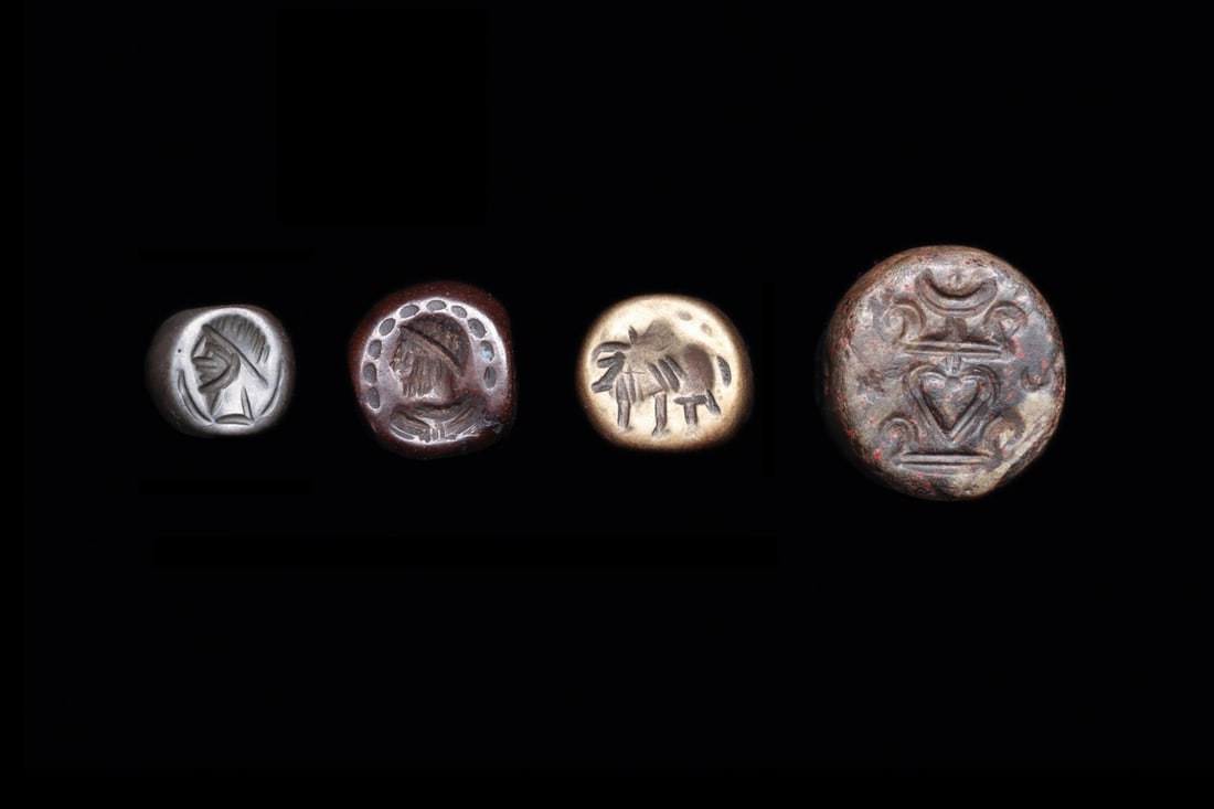 Sasanian Stamp Seal Group of Four with Bust, Bull and Nishan Devices: Western Asia, Sasanian Empire, ca. 400–600 CE. A quartet of domed stamp seals, each pierced through the shoulder for suspension and cut with a single device on the flat face. One is worked in a 