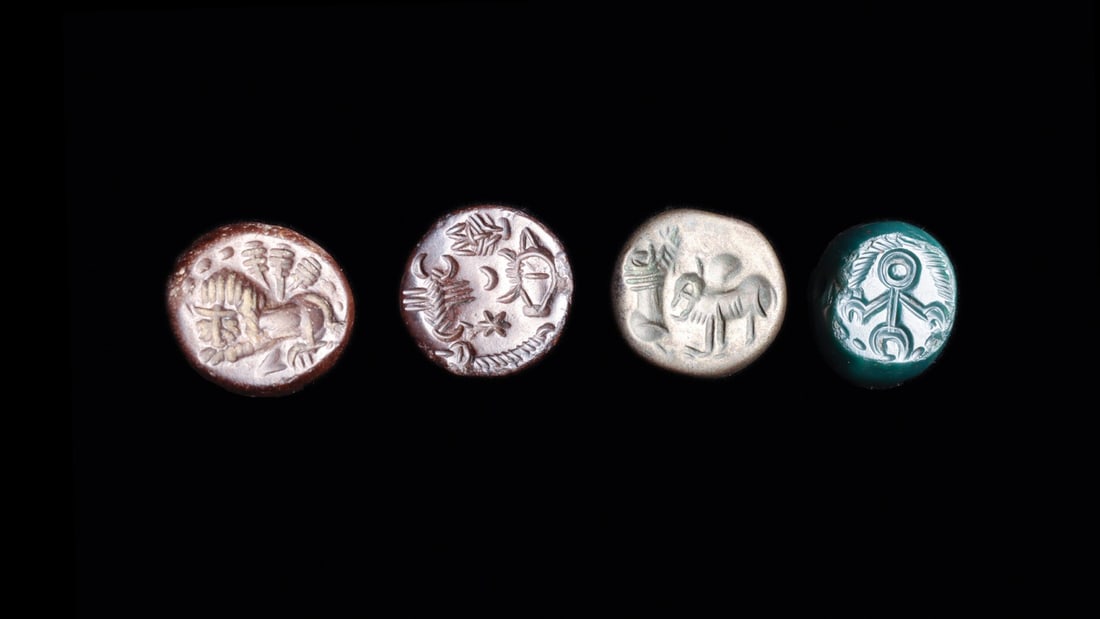 Sasanian Stamp Seals with Lion, Scorpion and Nishan Devices, Group of 4: Western Asia, Sasanian Empire, ca. 400–600 CE. A quartet of domed stamp seals, each drilled laterally for suspension and cut with a device on the flattened face. A brown agate carries a large re