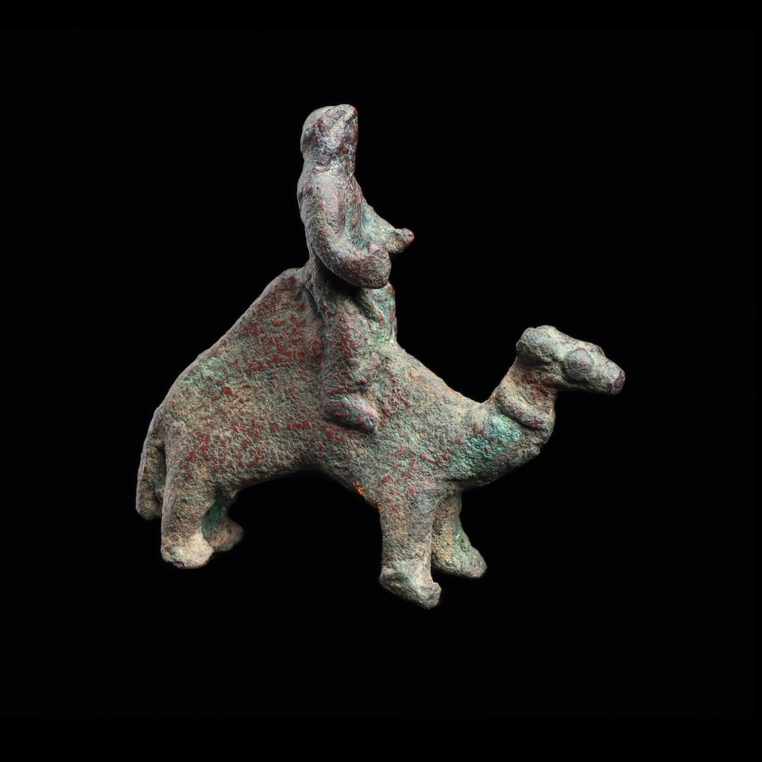 Nabatean Camel and Rider Miniature Figure: Near East, Jordan, Nabatean, ca. 1200–1000 BCE. A dromedary strides forward on four stout legs, its long neck arched and small head tipped up, while a rider sits astride the high hump. The group