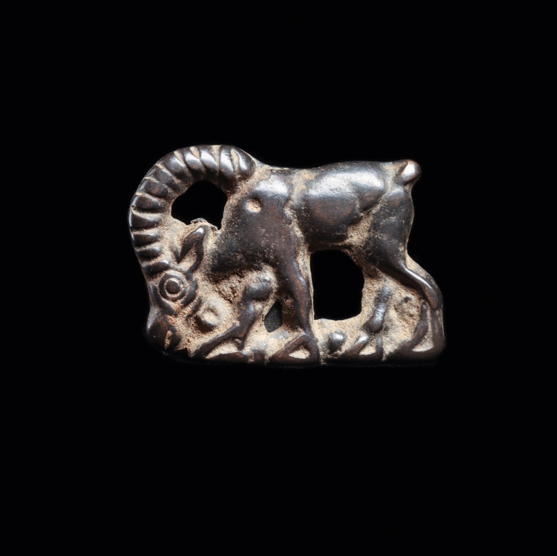 Ordos Miniature Bronze Age Ibex Plaque, Eurasian Steppe Animal Style: Eurasia, Ordos region, steppe nomadic cultures, ca. 500–100 BCE. A curl-horned ibex strides across this miniature cast plaque, its ribbed horn sweeping back in a full arc to meet the shoulder an