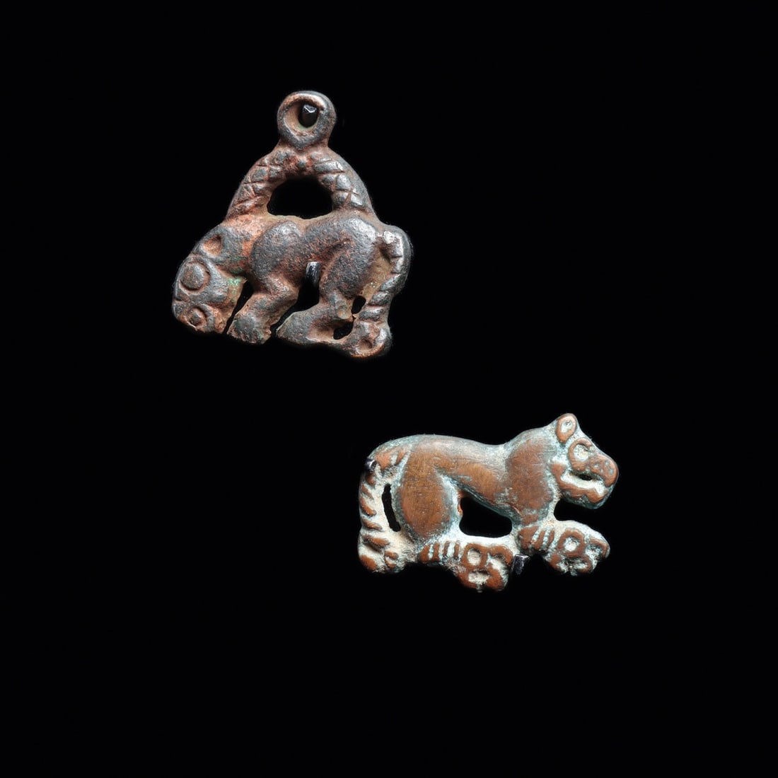 Ordos Feline Appliques, Pair, Miniature Steppe Animal-Style Plaques, 5th-1st C. BCE: Eurasia, Persia to Central Asian Steppes, Ordos culture, ca. 500–100 BCE. A pair of miniature cast appliques, each a crouching feline caught mid-stride, muscled haunches drawn tight and jaws par