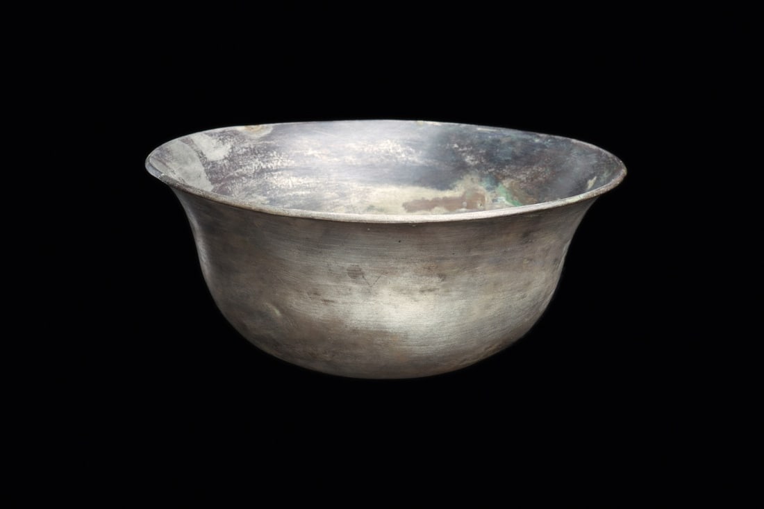 Greek Hellenistic Silver Bowl with Flared Rim, Magna Graecia, 4th-3rd C. BCE: Southern Italy, Magna Graecia, Greek, Late Classical to Hellenistic period, ca. 400–200 BCE. A thick-walled silver bowl raised to a deep, rounded body that swells from a curved base and opens in