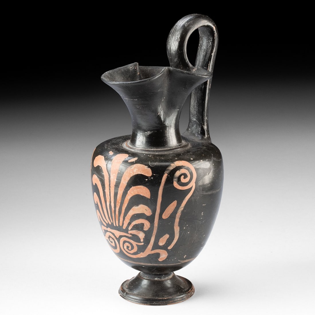 Apulian Trefoil Oinochoe, Greek Magna Graecia: Southern Italy, Apulia, Greek (Magna Graecia), ca. 350–320 BCE. A wine jug, or oinochoe, with an ovoid body on a molded ring foot, drawn upward into a slender neck opening into a trefoil mouth. 
