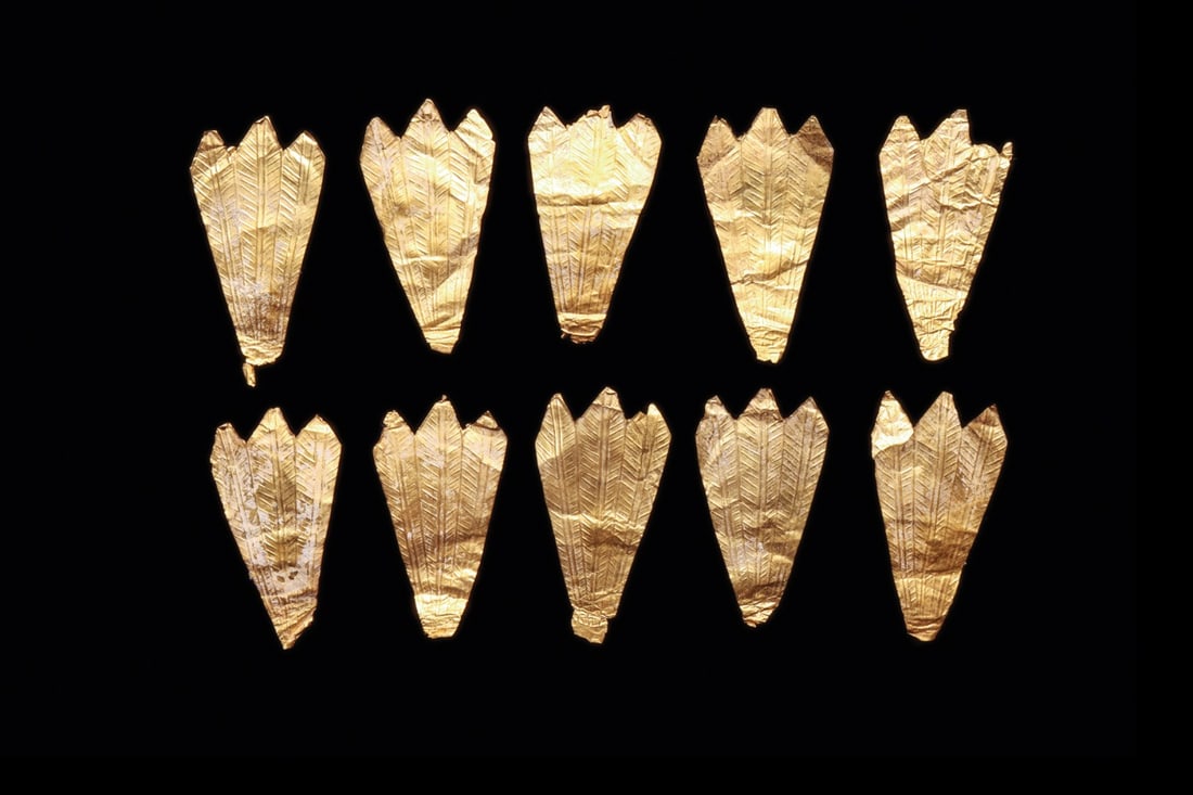 Greek Sheet Gold Diadem Appliques, Group of Ten Feather Forms: Southern Italy, Magna Graecia, Greek, ca. 500–200 BCE. A flight of ten sheet gold appliques, each hammered thin and worked into a fan of three overlapping feathers, their vanes rendered in fine 