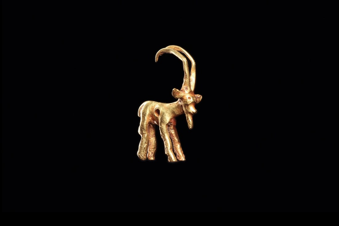 Thracian Gold Ibex Amulet, Long Horned Goat Pendant, 4th C. BCE: Southeastern Europe, Thrace, ca. 375–325 BCE. A small gold ibex stands alert on four slender legs, head lifted and sweeping ridged horns arcing back over the shoulders. Cast solid and finished b