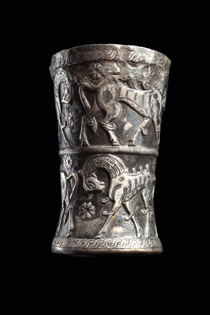 Marlik Silver Beaker with Parade Horses and Rosettes: Near East, Northern Persia, Caspian region, Marlik culture, ca. 1100–800 BCE. A waisted cylindrical beaker raised in sheet silver and worked in repousse, its walls framed above and below by guil