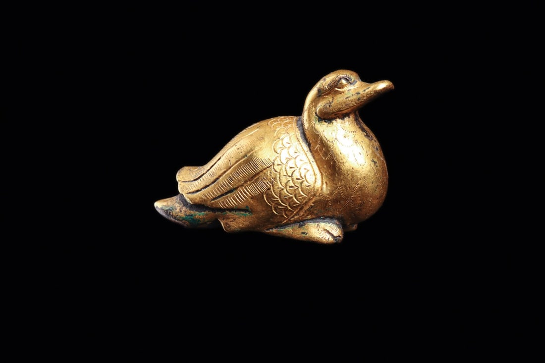 Ordos Miniature Gilt Duck Figure, Late 1st Millennium BCE: Eurasia, Central Asia Steppes, Ordos culture, ca. 400–100 BCE. A miniature waterfowl settled on its breast, cast in solid metal and finished with a warm gilt skin. The modeling is economical but