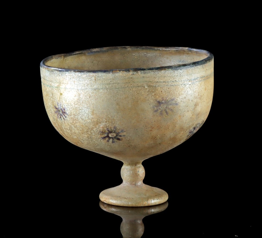 Late Roman / Byzantine Glass Chalice with Millefiori: Ancient Near East, Late Roman to Byzantine period, ca. 400–700 CE. A chalice hand-built from translucent honey-yellow glass, with a discoid foot beneath a spherical stem, a mastoid basin, and a 