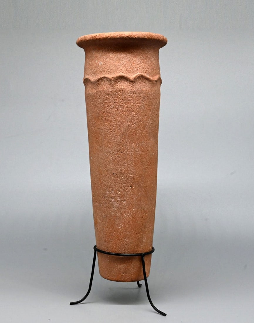Egyptian Pre-Dynastic Wavy-Handled Jar, Nile Clay: Egypt, Pre-Dynastic, Naqada culture, ca. 3100–3000 BCE. A tall, tapering cylinder of orange-pink marl clay, coil-built and hand-smoothed, rising to a wide mouth ringed by a short, everted rim. B