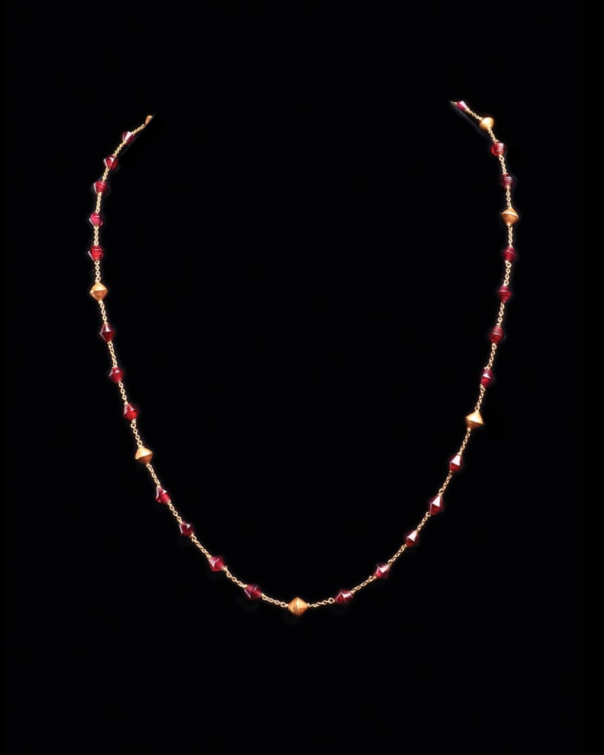 Egyptian New Kingdom Red Amethyst & Gold Bicone Bead Necklace, 19th-20th Dynasty: Egypt, New Kingdom, 19th-20th Dynasty, ca. 1350–1085 BCE. A single strand of thirty small double-conical red-amethyst beads alternating with nine gold beads of matching bicone profile, each ston