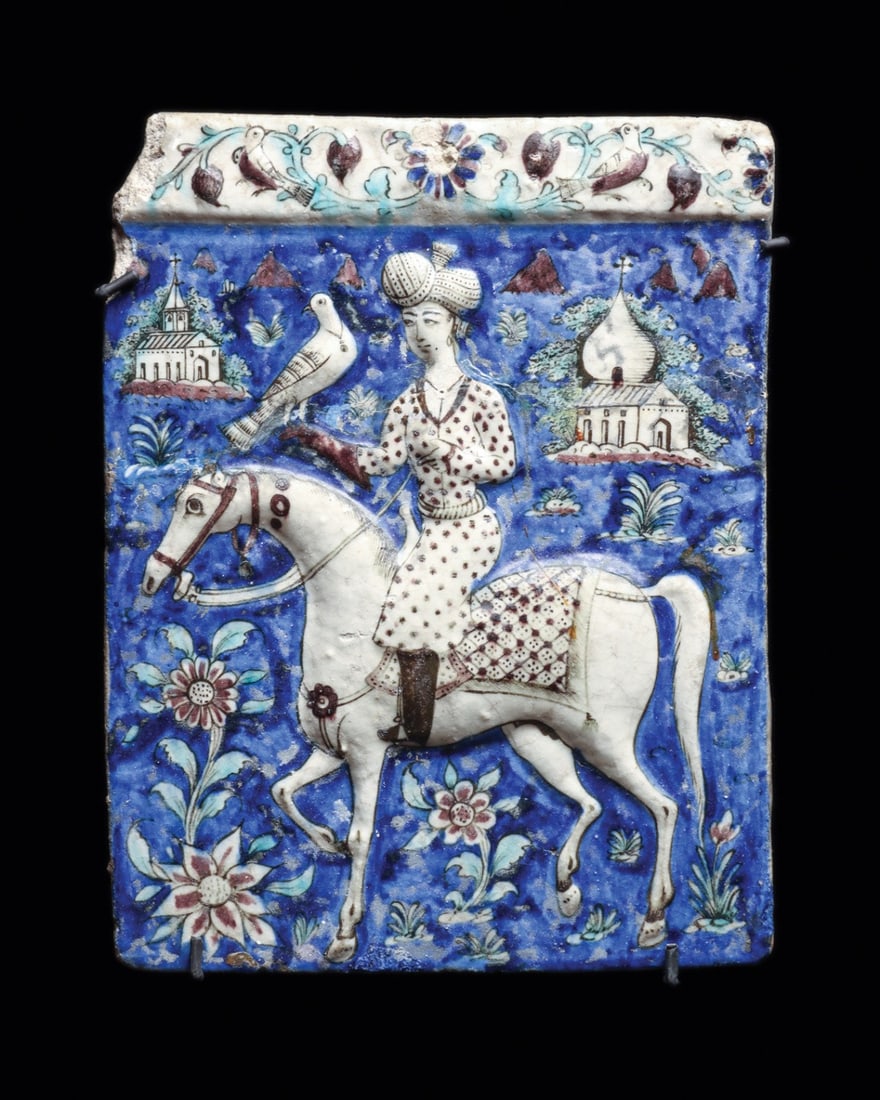 Persian Qajar Molded Relief Tile with Falconer on a White Horse: Near East, Persia, Qajar dynasty, ca. 1650–1800 CE. A falconer rides out across a cobalt ground, his hooded bird perched on a gauntleted fist, in this large molded and polychrome-glazed earthenw
