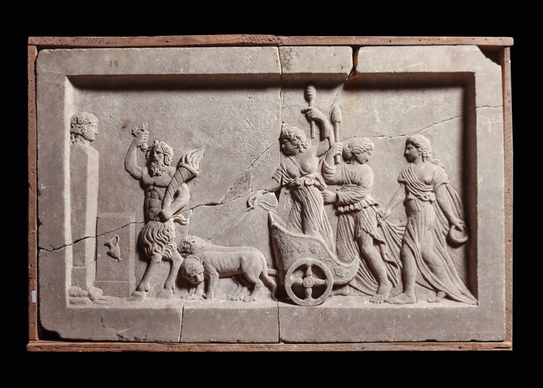 Cybele in Lion-Drawn Chariot Relief Stele with Pan and Attendants: Eastern Mediterranean to Asia Minor, ca. 1500–1800 CE. A carved stone panel in raised relief, its recessed field framed by a plain fillet border, presenting Cybele riding a two-wheeled chariot d