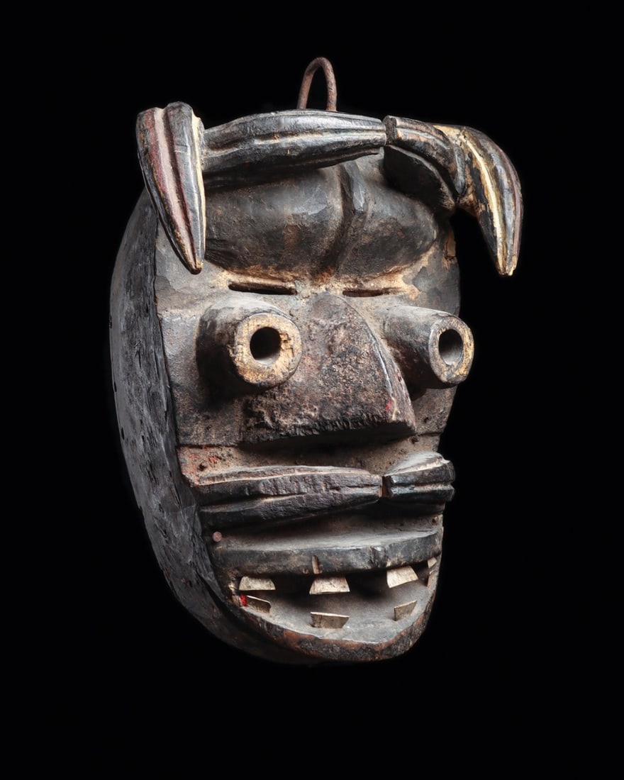 We Guere Spirit Mask with Tubular Eyes, Horns and Tusks, Ivory Coast: West Africa, Ivory Coast, We (Guere) culture, ca. 1900–1960 CE. A carved wood face conceived as a bundle of animal powers: two sets of upswept horns rise from the forehead, tubular eyes project 