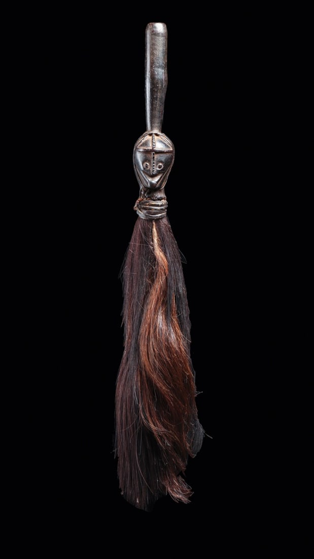 Ngbaka Fly Whisk with Carved Janus-Style Head, DR Congo: Central Africa, Democratic Republic of Congo, Ngbaka peoples, ca. 1900–1960 CE. A carved wooden fly whisk crowned by a human head in characteristic Ngbaka idiom: an ovoid face with raised scarif