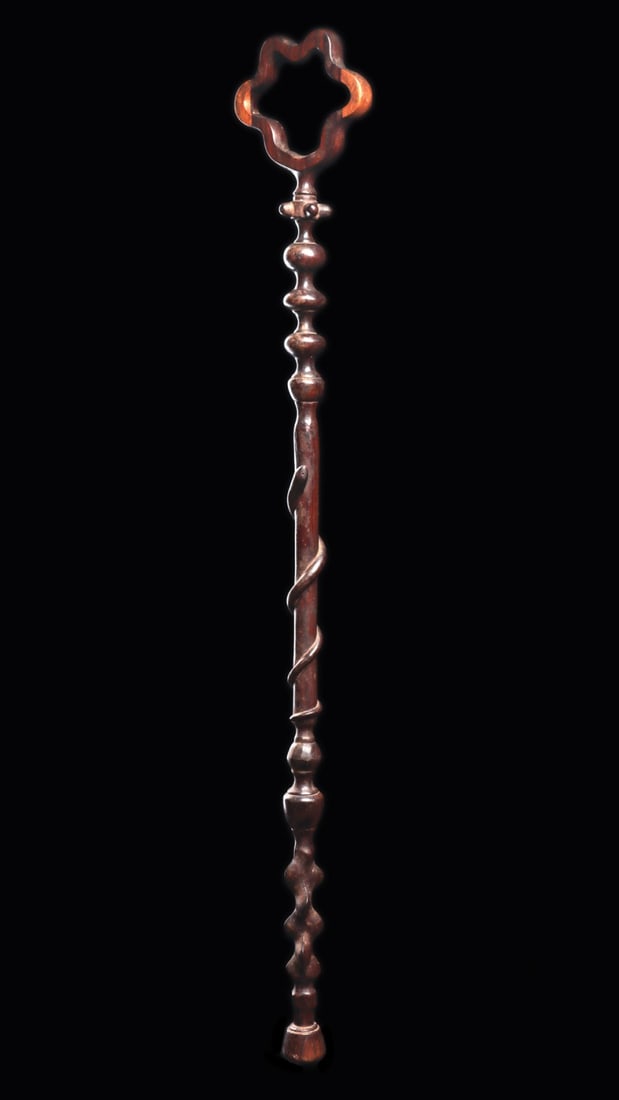 Zulu Prestige Staff with Serpent, 19th to Early 20th C.: Southern Africa, South Africa, Zulu, ca. 1850–1940 CE. A slender staff carved from a single length of dense, two-toned hardwood, crowned by an openwork quatrefoil loop above a knopped collar wit
