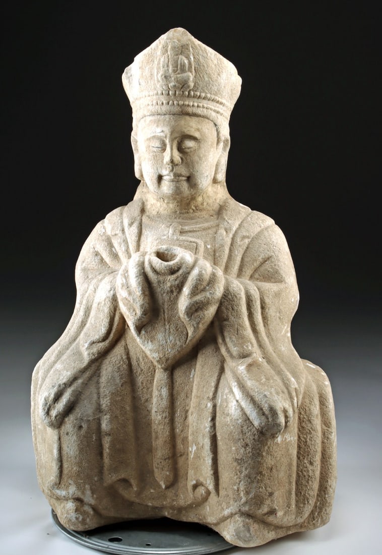 Large Ming Dynasty Chinese Stone Guanyin Sculpture: Ca. 1400–1700 CE. East Asia, China, Ming Dynasty, ca. 15th to 17th century CE. A carved stone sculpture of the bodhisattva Guanyin, seated with hands gathered at the waist in an offering gesture