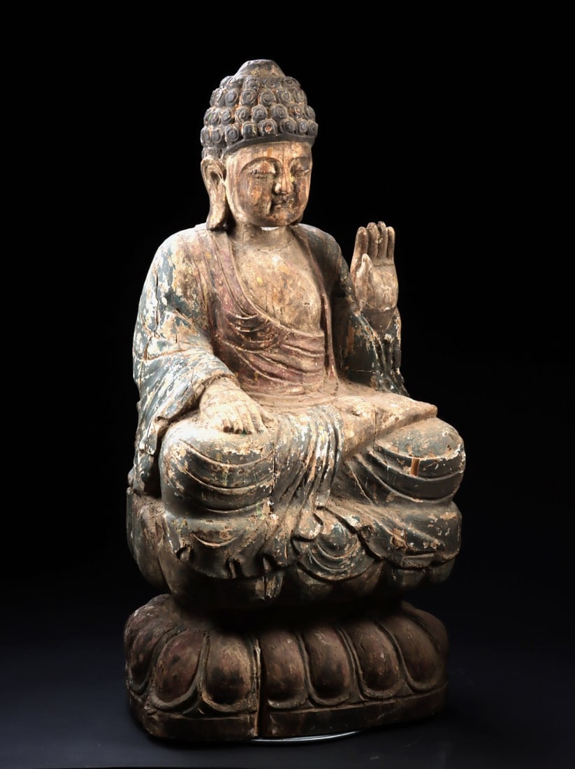 Large Ming Dynasty Wood Buddha - Seated on Lotus Throne, Abhaya Mudra: East Asia, China, Ming Dynasty, ca. 1368–1644 CE. A large Chinese carved wood figure of Buddha seated in dhyanasana on a double lotus base, the right hand raised in abhaya mudra and the left res
