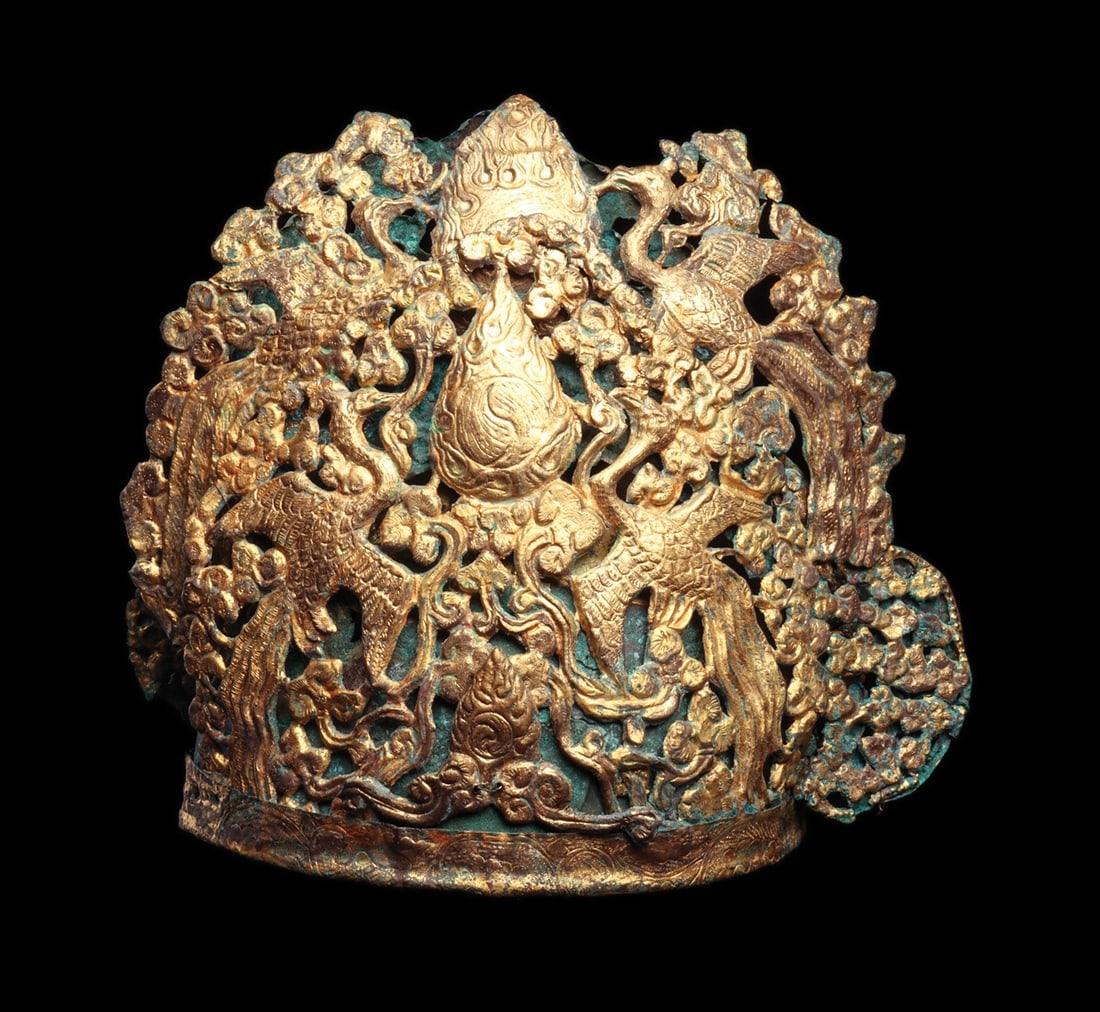 Tang Dynasty Gilded Crown with Phoenixes, Pagoda and Flames: East Asia, China, Tang Dynasty, 700 CE. A tall gilded crown assembled from sheet copper alloy, its domed inner cap built of three plates with a lower rim band and incised with a pair of peacocks amid 