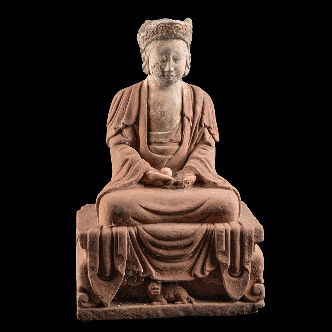 Chinese Sandstone Bodhisattva Figure | Cintamani Jewel: East Asia, China, Qing Dynasty, ca. 1644–1912 CE. A bodhisattva figure seated in meditation, carved from reddish sandstone. The figure has downcast eyes and a rounded face, framed by a foliate c