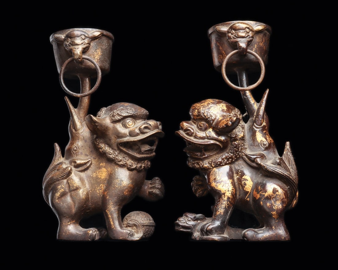 Chinese Pair of Guardian Lion Incense Stands with Gilt Traces, 18th-19th C.: East Asia, China, late Ming to Qing Dynasty, ca. 1700–1899 CE. A matched pair of cast guardian lions, one with the right forepaw raised, the other with the left, heads turned toward each other w