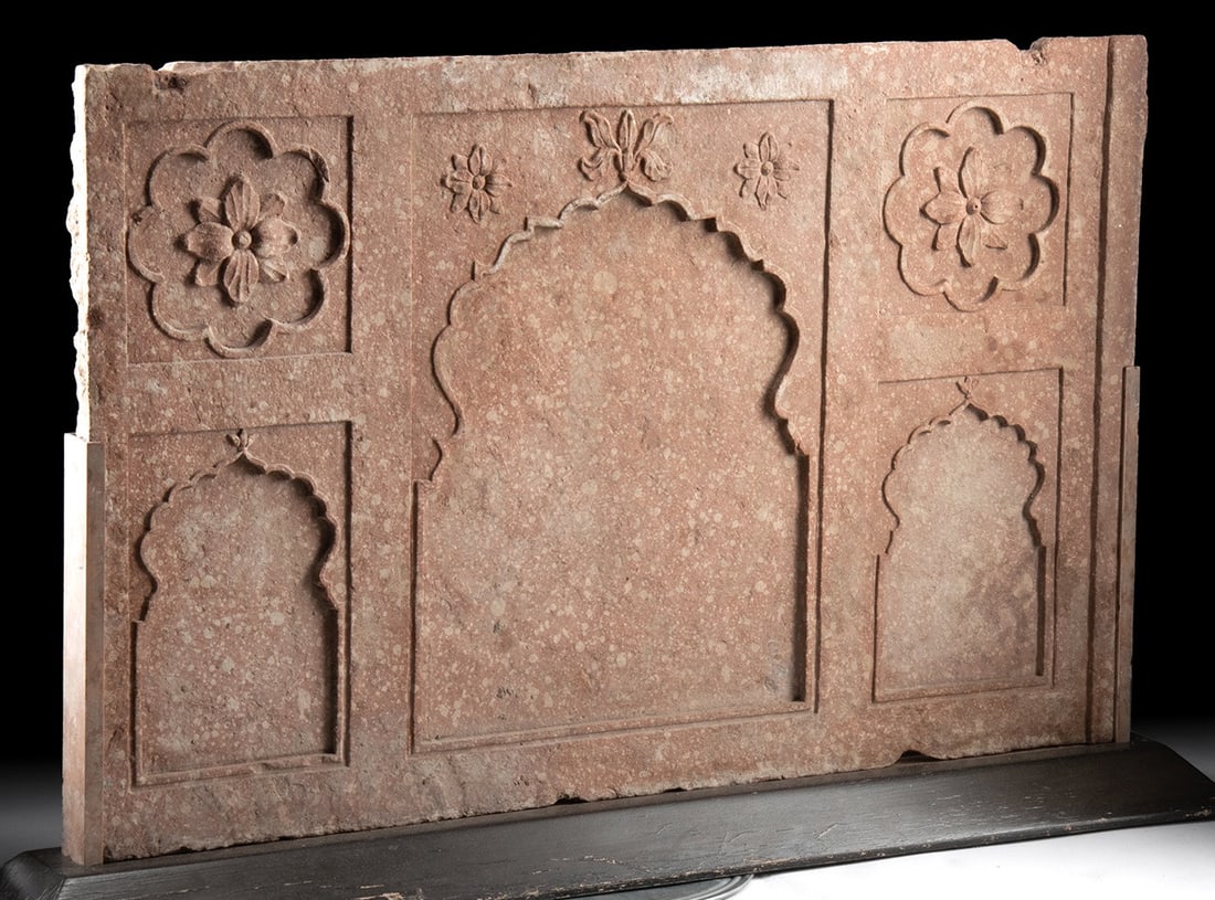 18th C. Mughal Carved Sandstone Panel, ex-Sotheby's: Ca. 1700–1800 CE. South Asia, India, Northern region, ca. 18th century CE. A large carved architectural panel of mottled pink sandstone, rectangular in form, adorned with Mughal motifs. The reli