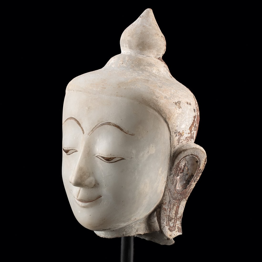 17th C. Burmese Shan Style Gilded Alabaster Buddha Head: Southeast Asia, Burma, Shan States, ca. 1600–1799 CE. Southeast Asia, Burma (Myanmar), Shan style, ca. 1600 to 1799 CE. A Buddha head carved from pale alabastrine marble, with downcast eyes abov