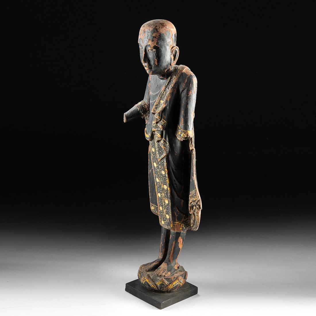 19th C. Burmese Mandalay Wood Buddha, Glass Inlay: Southeast Asia, Myanmar (Burma), Mandalay period, ca. 1800–1899 CE. A standing Buddha figure carved from a single block of wood. The oval face has arched brows, downcast eyes, and a smiling mout