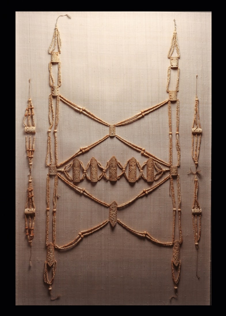 Tibetan Carved Bone Ritual Apron (Rus Gyan) with Arm Ornaments, 19th C.: East Asia, Tibet, Tibetan Buddhist, ca. 1800–1899 CE. A tantric ritual apron, or rus gyan, assembled from thousands of hand-cut bone beads strung into swagged lattices and anchored by pierced op
