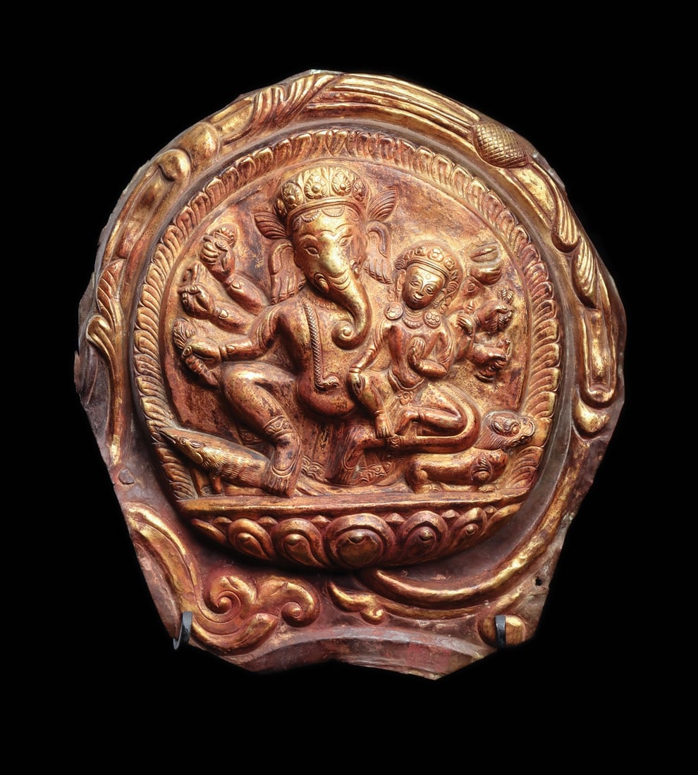 Nepalese Gilt Repousse Plaque of Ganesha with Consort, 16th C.: Himalayas, Nepal or Tibet, ca. 1500–1599 CE. A gilt repousse plaque worked in high relief, its rounded field enclosed by a beaded roundel and a foliate outer border of scrolling leaves and cloud