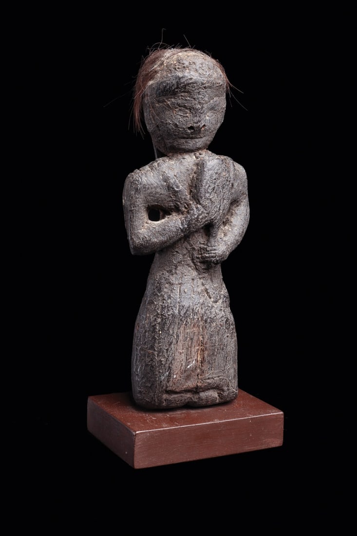 Jhankri Shaman Figure with Dhyangro Drum, Nepal, 19th C.: Himalaya, Nepal, ca. 1800–1899 CE. A small standing figure carved in dense hardwood, its surface worn to a grey, weather-scoured patina, depicting a jhankri, the traditional Nepalese faith heale