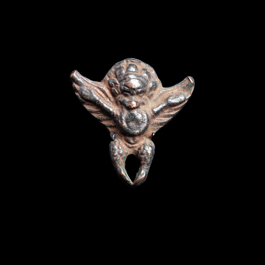 Tibetan Thokcha Amulet of the Garuda with Spread Wings, Miniature: Himalayas, Tibet, ca. 1000–1600 CE. A miniature cast amulet in the form of the garuda, the solar bird deity of Himalayan Buddhism, its wings flung wide and its talons drawn together beneath a ro