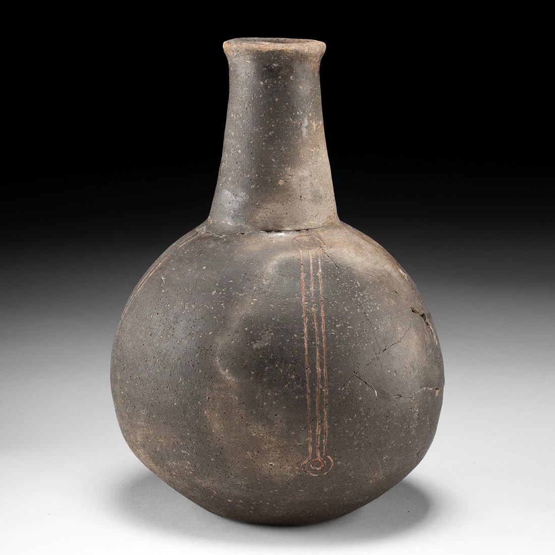 Caddo Blakely Engraved Bottle: Native American, Arkansas, Caddo, ca. 1200–1500 CE. A globular ceramic bottle swelling to a full spherical belly, then drawn up into a tall, slightly flaring neck that finishes in a rolled lip. 