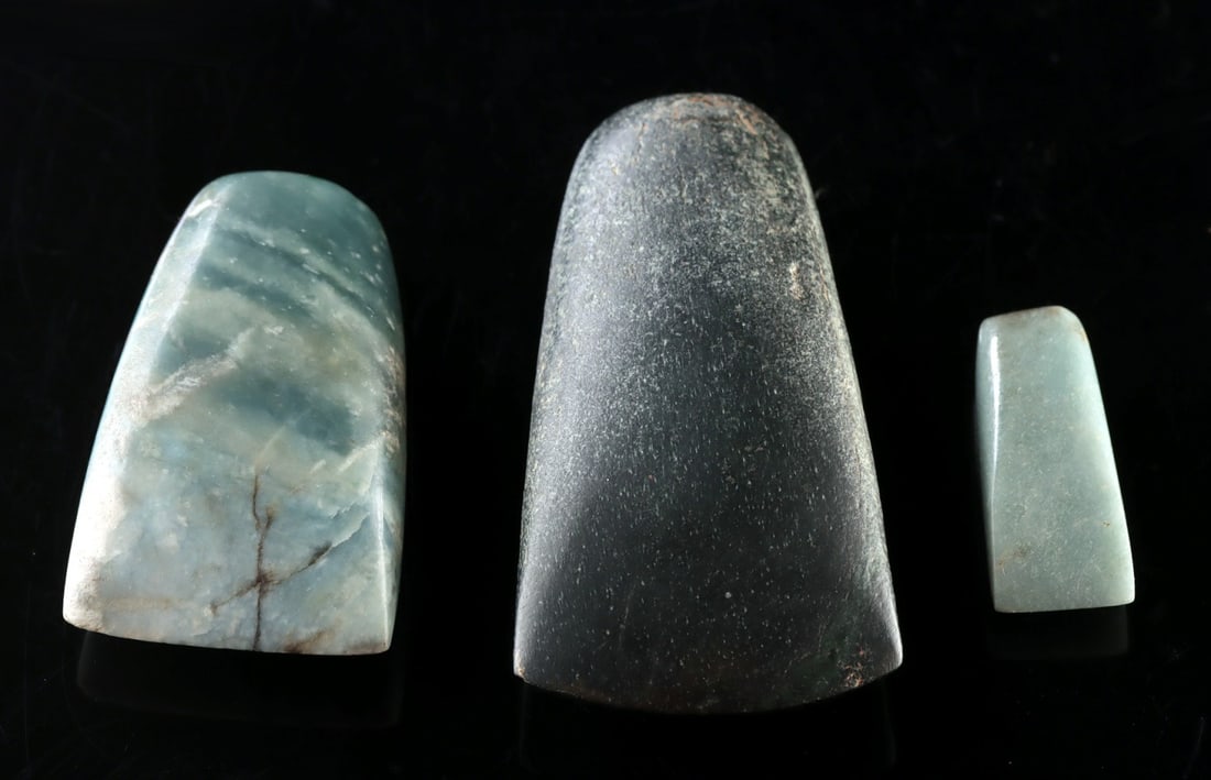 Three Maya Greenstone Celts: Ca. 301–351 CE. Pre-Columbian, Mesoamerica, Maya. A group of three polished greenstone celts representing the prestige lapidary tradition of the ancient Maya. The celt form, a trapezoidal blade 