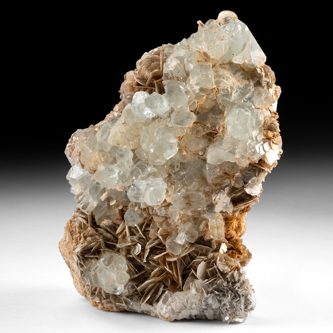 Aquamarine & Muscovite Mica Mineral Specimen: Ca. 1–5 million years old. Central Asia, ca. millions of years ago. A substantial aquamarine and muscovite mica association specimen, featuring pale blue-green aquamarine crystals clustered acro
