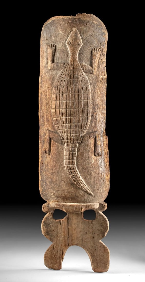 19th C. West African Mali Wood Chair Panel w/ Crocodile: Ca. 1800–2000 CE. West Africa, Mali, Bamana Dogon, Senufo People, ca. 19th to early 20th century CE. A massive wood panel with a slightly curved shape and a relief carved crocodile or lizard upo