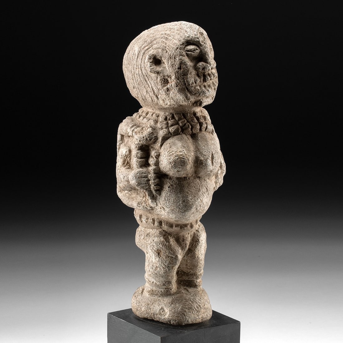 Sierra Leone Stone Nomoli Figure - Mother & Child: West Africa, Sierra Leone, Sherbro or Mende peoples, ca. 1930–1970 CE. A squat, powerfully compressed figure carved from pale soft stone, standing on flexed legs with a heavy pregnant belly thru