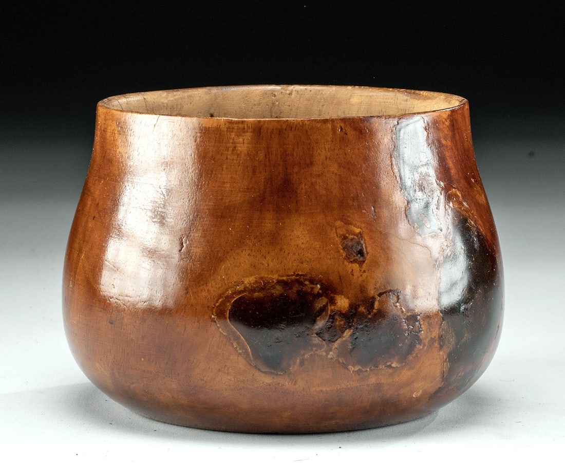 20th C. Hawaiian Tropical Hardwood Bowl: Ca. 1934–1967 CE. Polynesia, Hawaii, ca. mid 20th century CE. A beautiful bowl made from tropical hardwood with its exterior polished to a high sheen. The bowl bulges out at its waist before nar