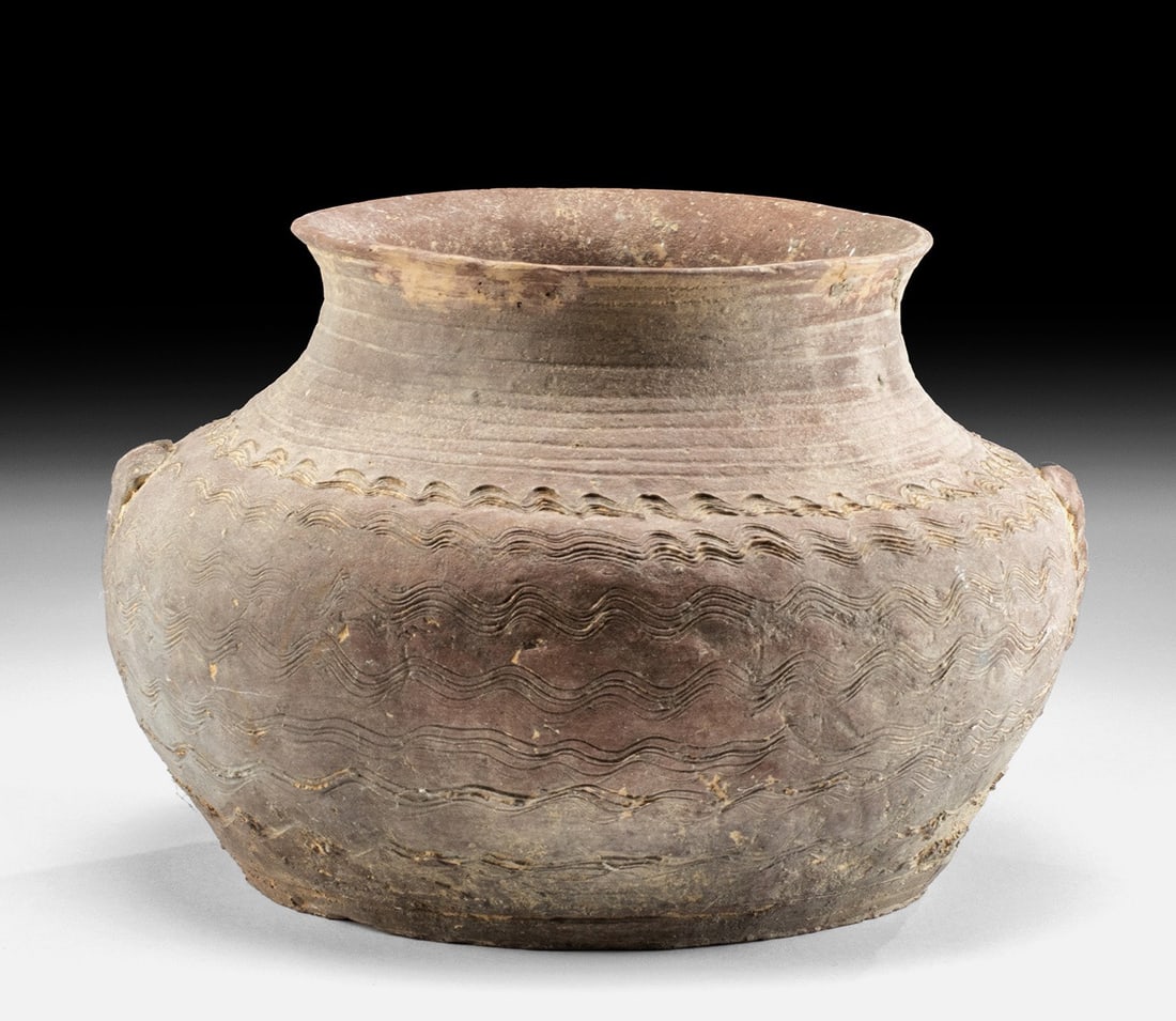 Chinese Warring States / Han Pottery Jar: Ca. 400–200 BCE. East Asia, China, late Warring States period to early Western Han Dynasty, ca. 400 to 200 BCE. A lovely hand-built pottery jar presenting an apple-form body that narrows to a sl