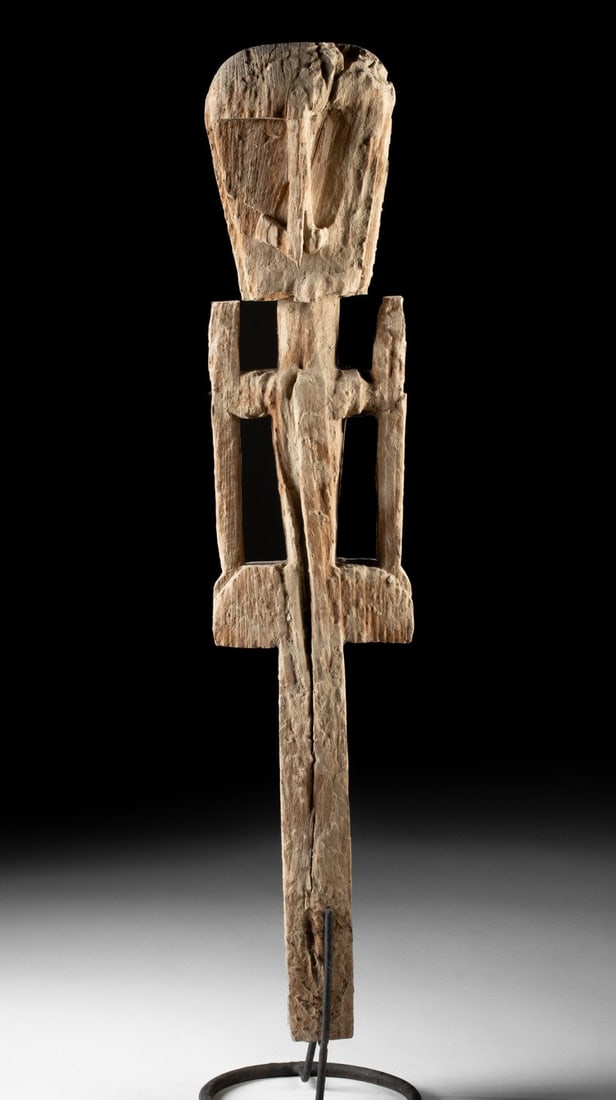 Indonesian New Guinea Wood Ancestral Figure Post, Openwork Arms: Southeast Asia, Indonesia, Western New Guinea, ca. 1800–1933 CE. A carved wooden ancestral figural post, featuring an oversized head with angular facial planes, openwork arms, and a weathered su