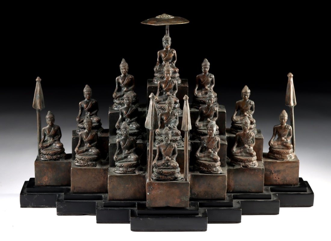 20th C. Indonesian Brass Buddha Grouping - 16 Figures on Tiered Stand: Southeast Asia, Indonesia, ca. 1900–1999 CE. A congregation of sixteen cast brass Buddhas ascends a stepped wooden platform, each figure seated in meditative repose upon its own pedestal block. 